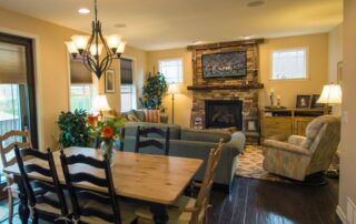 cozy mountain home living room with stacked stone fireplace