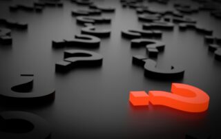 question marks scattered on a flat surface